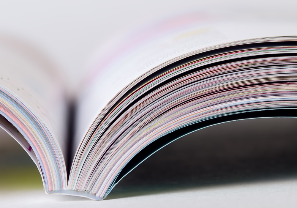 Colorful pages of an open magazine, close up. Selective focus.