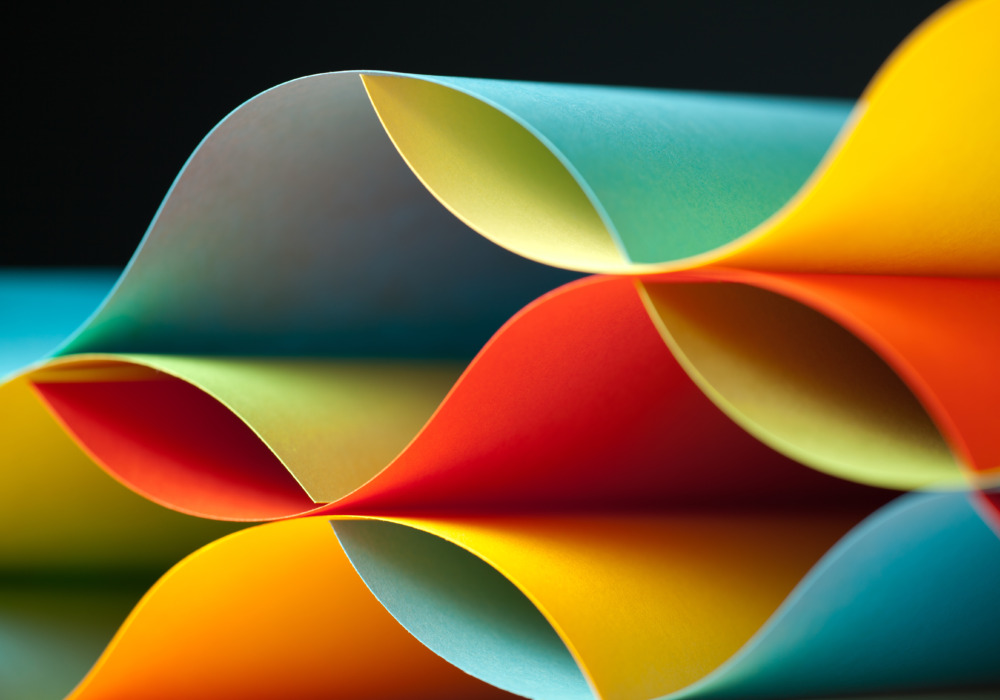 Graphic abstract image of colorful origami pattern made of curved sheets of paper