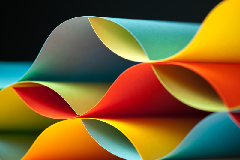 Graphic abstract image of colorful origami pattern made of curved sheets of paper