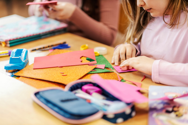 A schoolgirl making art project at art in elementary school.